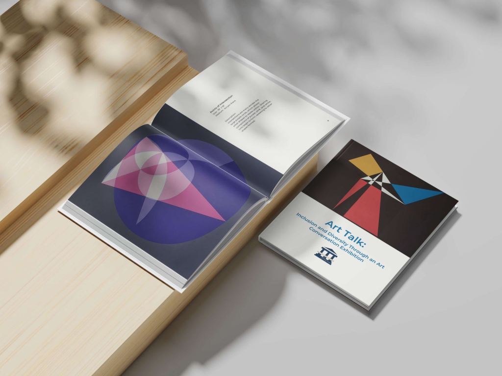 Art Talk Museum Catalog Book shown open pages and front of book on wood pieces